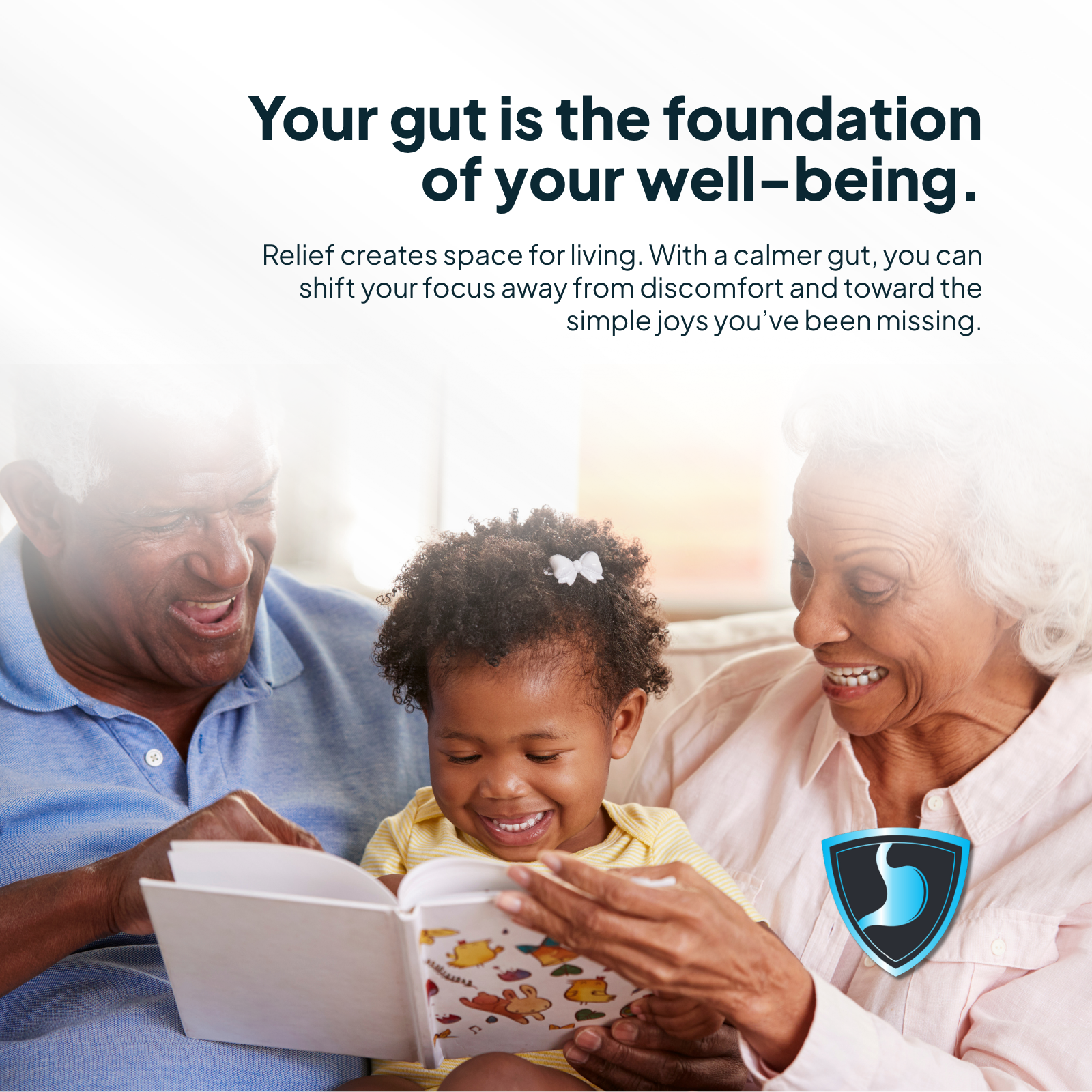 Grandparents reading a book to a young girl with a product logo in the corner.