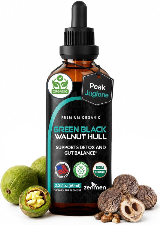 A 2-32 oz amber glass dropper bottle of Zenimen Green Black Walnut Hull dietary supplement, surrounded by fresh green walnuts and cracked walnut halves on a white background.